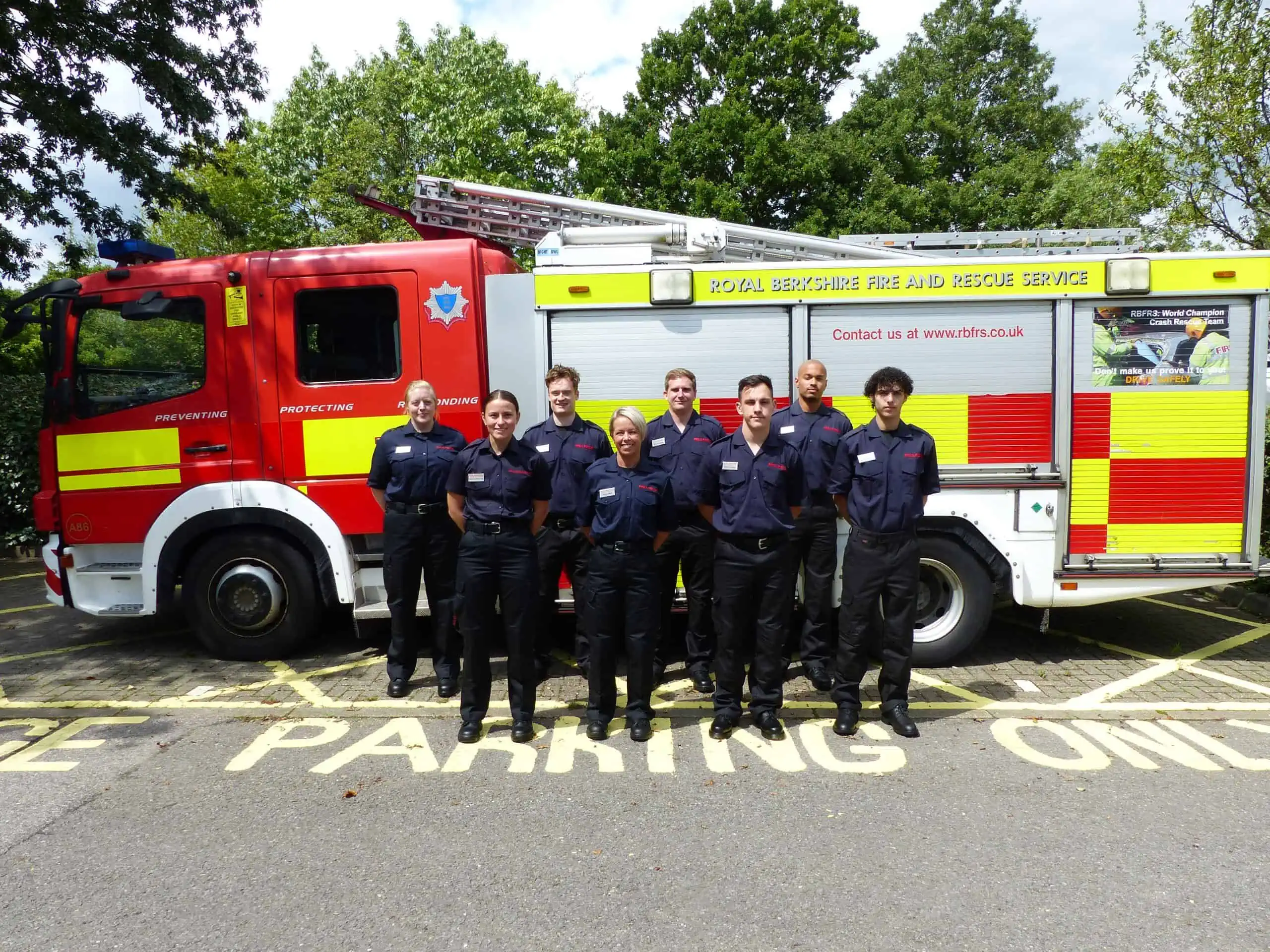 A group of Firefighter Apprentices stood in front of Fire Engine.
