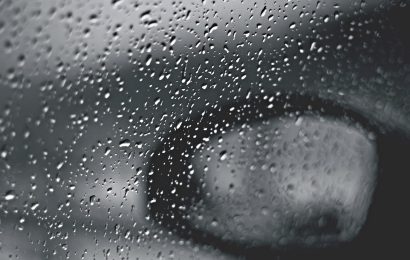 An image of a car wing mirror in the rain