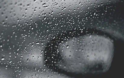 An image of a car wing mirror in the rain