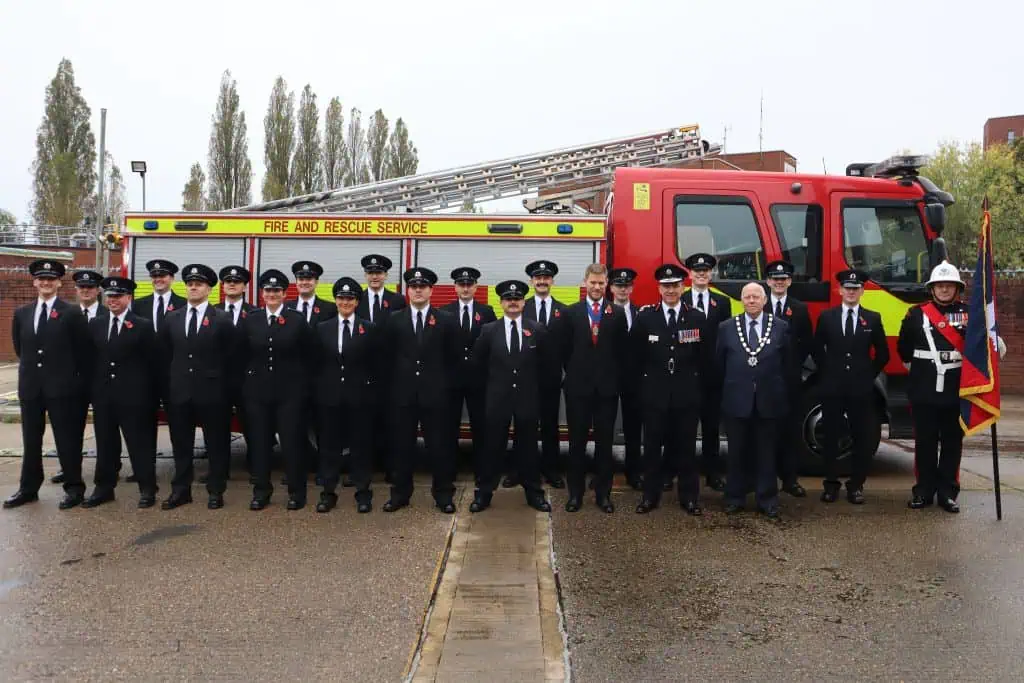 Wholetime Firefighter Graduates lined up in front of a fire engine.