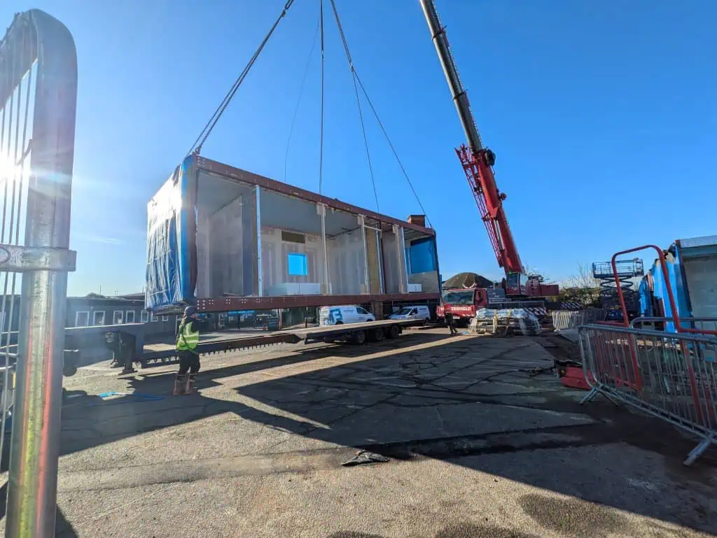 Part of the new Training Centre building being lifted into place by crane.