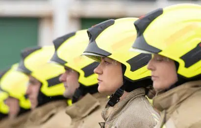 Firefighters wearing helmets lined up