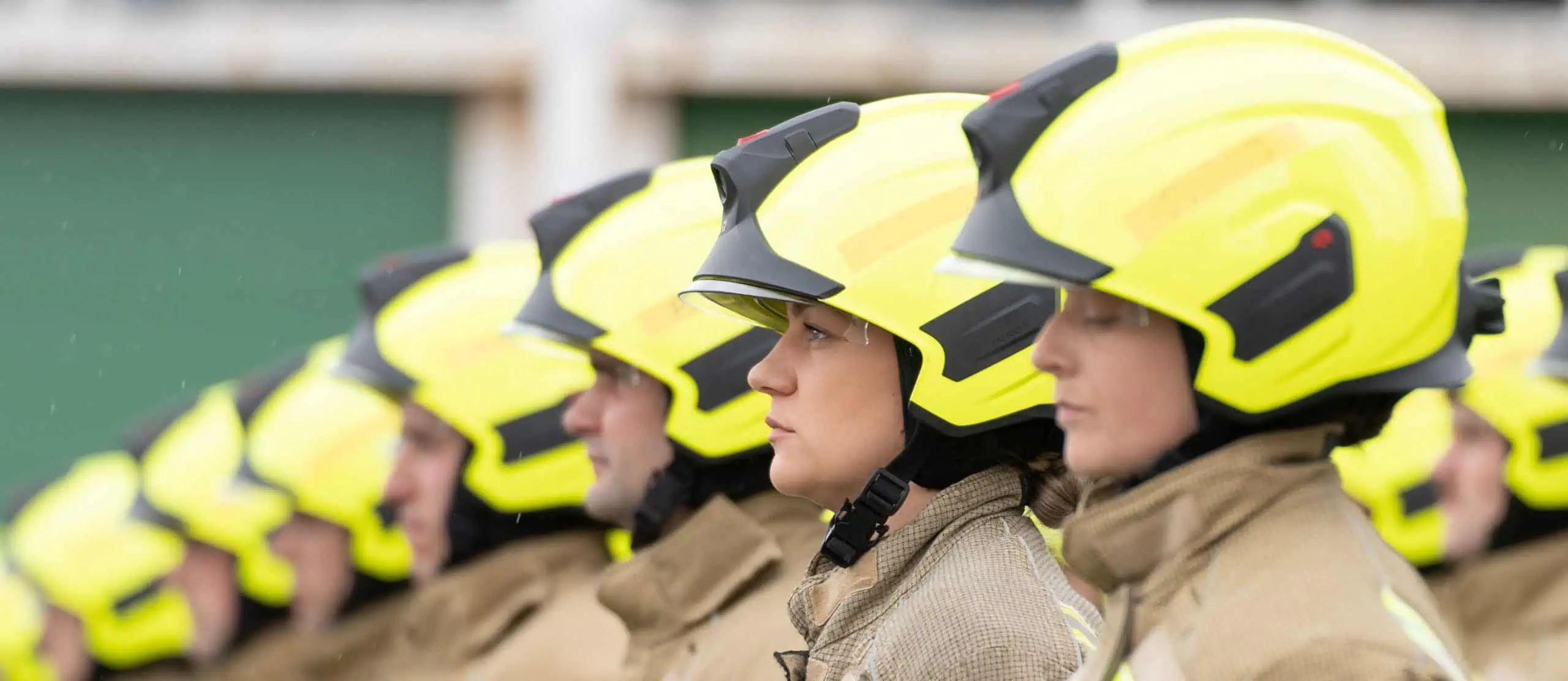 Firefighters wearing helmets lined up